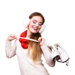 Woman wearing ear muffs holding ice skate
