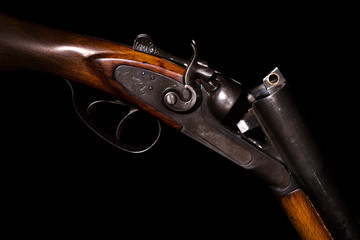 Double-barreled shotgun on a black background - obrazy, fototapety, plakaty