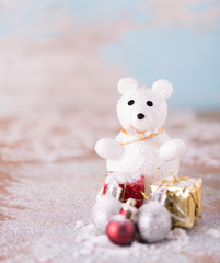Shiny white Christmas balls and white cute bear over snow backgr