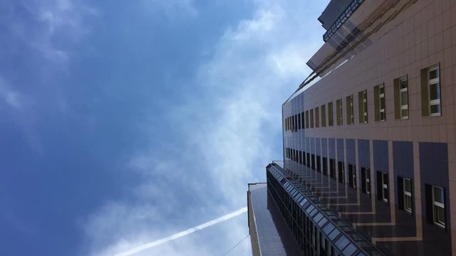 Corporate buildings and time lapse clouds.