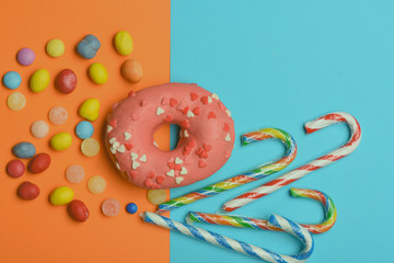 Pink glazed donut on colorful background