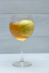 Green apple in glass with juice