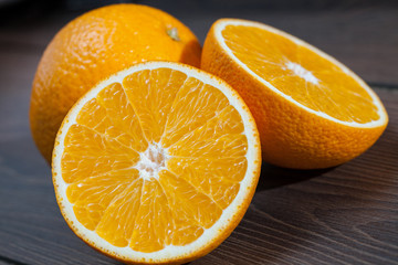Ripe oranges on wooden background