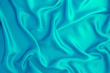 Close up wave light blue silk or satin fabric background