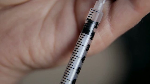 Girl picking up insulin in a syringe close-up.  Diabetes. 