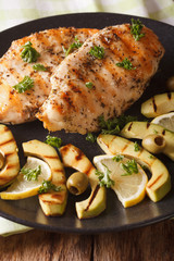 Diet Food: Grilled chicken breast with avocado, lemon and olive close-up. vertical