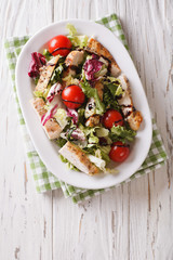 Tasty salad of grilled chicken, tomatoes and herbs with balsamic sauce. Vertical top view