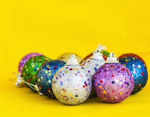 multicolor christmas ball on yellow background