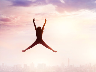 Fototapeta na wymiar Woman enjoy jumping while chilling out on city sky, nature background