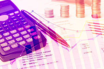 Calculator and pen with graph, coins for finance and banking con