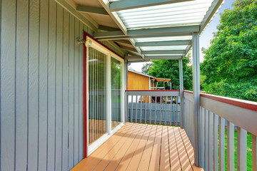 Two story gray house exterior. Balcony view