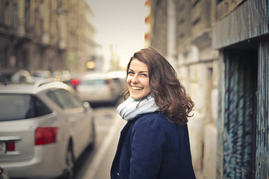 Smiling girl walking in the street