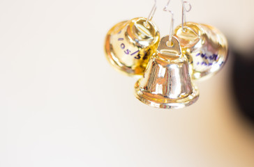 golden christmas bells hanging as new year toys and gift defocus