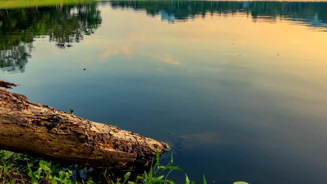 (4k) Time lapse of beautiful landscape in the everning with reflected on water in Lakes, trees and cloudy sky. Camera Pan