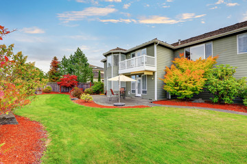 Well kept Backyard garden and patio area of American house.