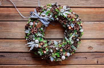 Christmas wreath on wooden rustic background.