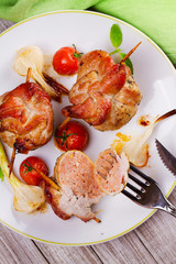 Meat rolls on scewers with cherry tomatoes and garlic. View from above; top studio shot