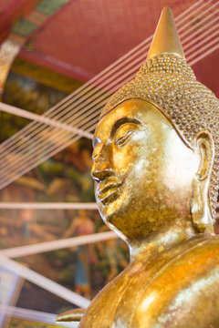 Closeup of the face and hands of buddha's image covering with go