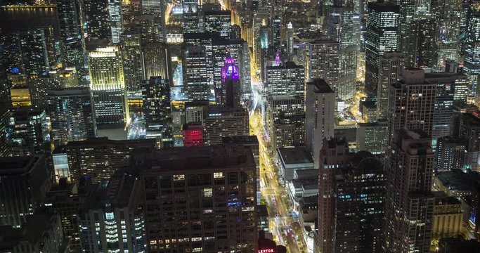 Chicago, Illinois, USA - view from the observatory of the John Hancock Center at illuminated City along Michigan Avenue at night with Tribune and Trump Tower - Timelapse without motion 