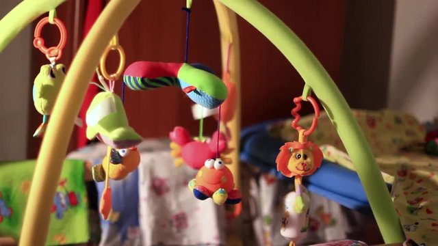 toys hanging in the crib