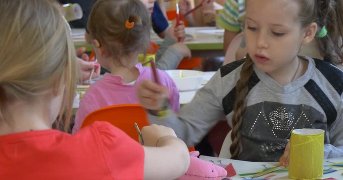 the Girl With Pigtails Concentrates at the Task.