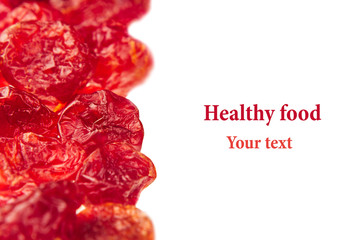 Dried cherries closeup on white background. Isolated. Decorative border of glossy red dried cherry. Dried fruit for vegetarian.