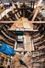 repair old wooden fishing boat. Large ocean boat. Traditional Scandinavian wooden ships. ship repair workshop.