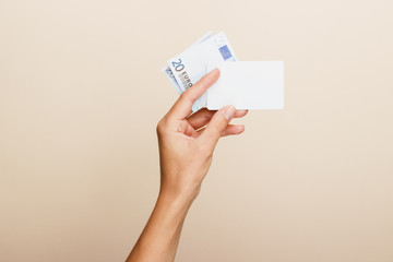 Woman's hand with money on a light background