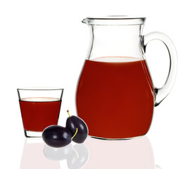 plum juice in a glass and carafe on a white background
