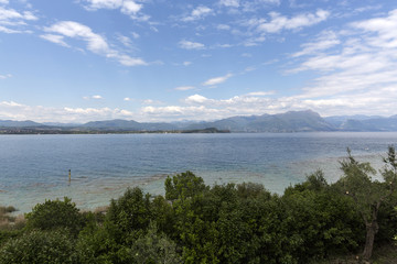 Fototapeta na wymiar Landscape of the coast of Sirmione peninsula which divides the lower part of Lake Garda. It is a famous vacation place for a long time in northern Italy.