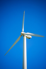 Wind generator, on a background of blue sky.