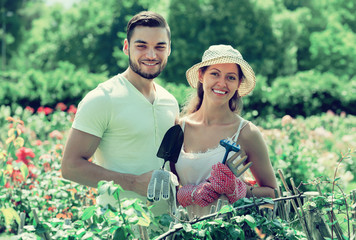 Young couple gardening together .