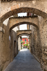 Obraz na płótnie Canvas Picturesque narrow town street in Sirmione, Lake Garda Italy.