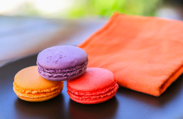 Cookies macaroons, turnovers, red, orange and purple.