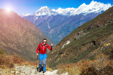 Fototapeta premium Young Hiker walking on Mountain Trail Sun on Background