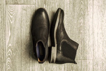 Fashion concept with male shoes on wooden background