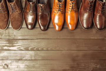 Fashion concept with male shoes on wooden background