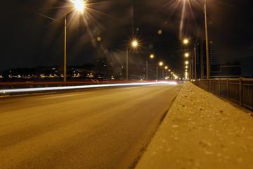 Fototapeta na wymiar Night road and light lines after cars