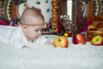 Fototapeta na wymiar Newborn baby and apples, Russian style.