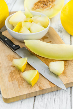 Portion of Yellow Honeydew Melon on wooden background (selective