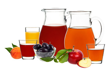 apple, plum and peach juice in glasses and decanters