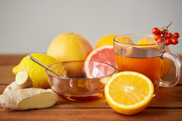 tea with honey, lemon and ginger on wood
