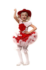 Cute little caucasian girl wearing red skirt, t-shirt with flowers and cowboy hat isolated on white background. She is dancing.