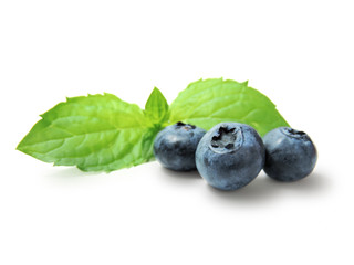 Fresh blueberries with mint leaf, isolated on white background.
