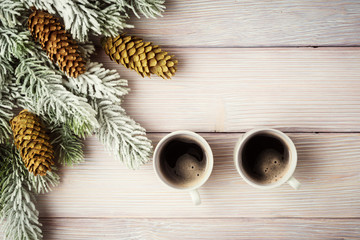 Xmas background with fir tree and two cups of coffee