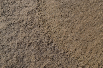 Fototapeta na wymiar Sandstone. Texture. Dark yellow sandstone with a semicircle of a lighter color.