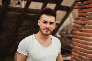 Attractive guy with white t-shirt in a old house