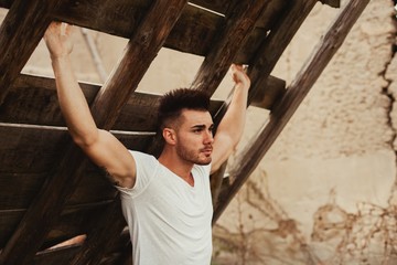 Attractive guy with white t-shirt in a old house