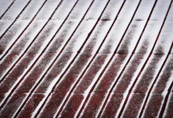 red metal roof dusted with snow