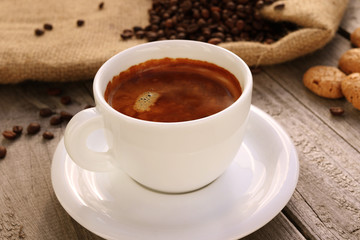 Cup of hot coffee on wooden surface